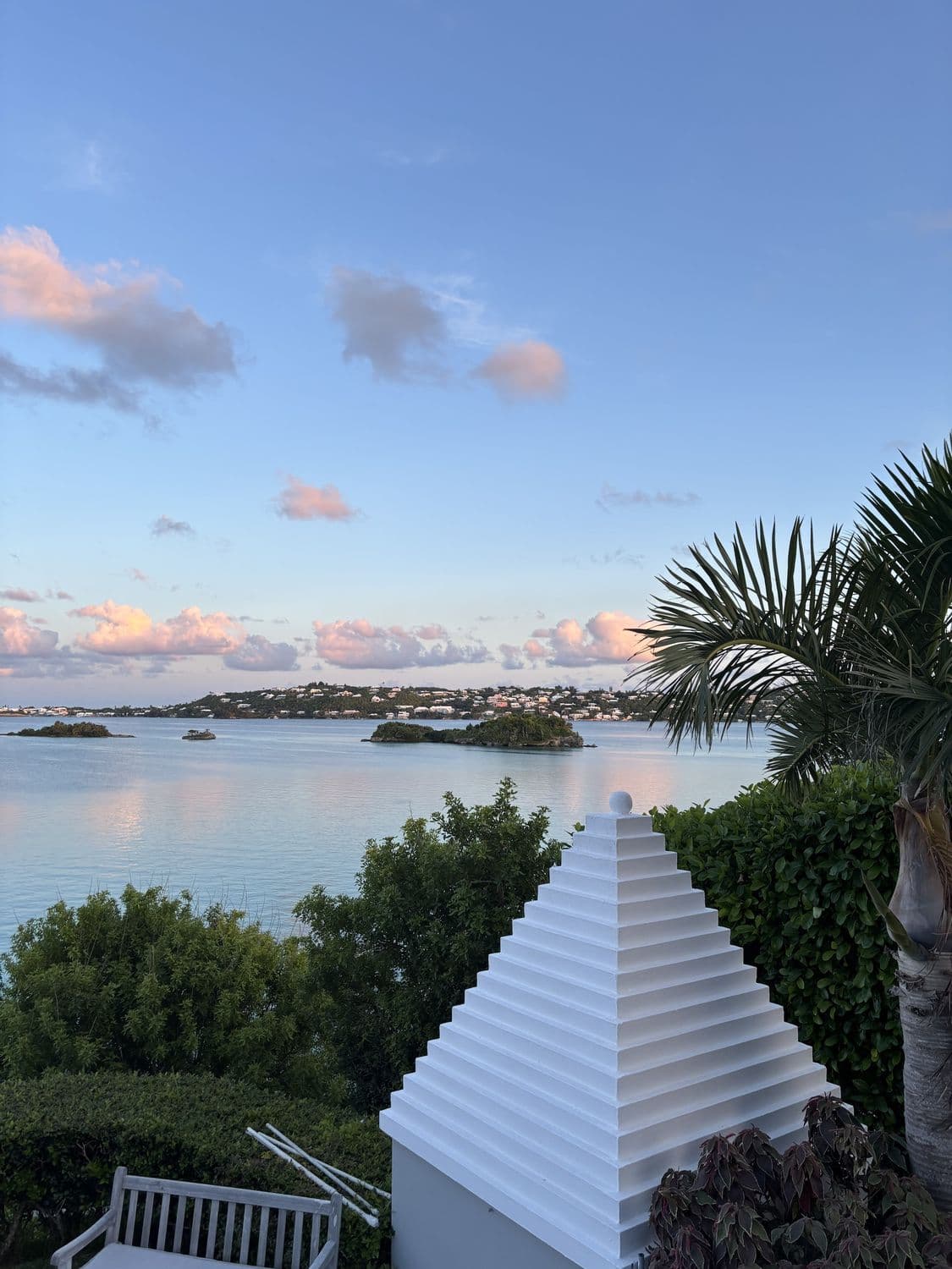 A white stepped Bermuda roof above the harbour at sunset